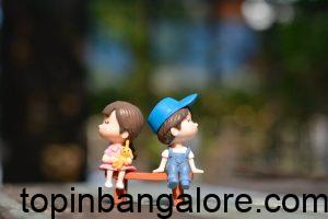 Romeo and Juliet love story boy and girl sitting on bench toy
